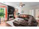 Comfortable living room with fireplace, ceiling fan, hardwood floors, and neutral walls at 3124 Arklow Rd, Charlotte, NC 28269