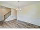 Dining area with hardwood floors, wainscoting, and a modern light fixture, located adjacent to staircase at 3242 Bozeman Ct # 8, Stanley, NC 28164