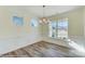 Dining room featuring hardwood floors, wainscoting, modern light fixture, and multiple windows at 3242 Bozeman Ct # 8, Stanley, NC 28164