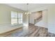Bright dining area with hardwood floors, wainscoting, modern light fixture, and large window at 3242 Bozeman Ct # 8, Stanley, NC 28164