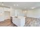 Beautiful kitchen with a large center island with stainless steel sink and bright, white cabinets at 3242 Bozeman Ct # 8, Stanley, NC 28164