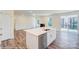 Open-concept living space showcasing a kitchen island with stainless steel sink, and a view to the living room at 3242 Bozeman Ct # 8, Stanley, NC 28164