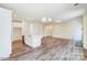 Open-concept living room and kitchen area with hardwood floors, stainless steel appliances, and a kitchen island at 3242 Bozeman Ct # 8, Stanley, NC 28164