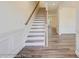 Elegant staircase with wood railing and luxury vinyl plank flooring, leading to the upper level at 3242 Bozeman Ct # 8, Stanley, NC 28164
