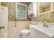 Bathroom with vintage floral wallpaper, window, and white vanity with sink at 3624 Delgany Dr, Charlotte, NC 28215