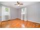 Bright, empty bedroom with two windows offering plenty of natural light and hardwood floors at 3624 Delgany Dr, Charlotte, NC 28215