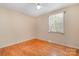 Empty bedroom featuring hardwood floors, a window, and neutral paint colors at 3624 Delgany Dr, Charlotte, NC 28215