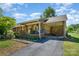 Ranch home showcasing a covered front porch, carport, and landscaped yard with mature trees on a sunny day at 3624 Delgany Dr, Charlotte, NC 28215
