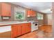 Retro kitchen featuring unique orange cabinets, bright countertops, and vintage appliances at 3624 Delgany Dr, Charlotte, NC 28215