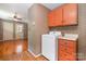 Laundry room with a washing machine and storage, featuring wood floors and patterned wallpaper at 3624 Delgany Dr, Charlotte, NC 28215