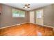 Living room featuring hardwood floors, ceiling fan, and an exterior entrance with large window on the door at 3624 Delgany Dr, Charlotte, NC 28215