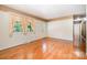 Inviting living room with hardwood floors, large windows, and a doorway leading to hallway and an outdoor entry at 3624 Delgany Dr, Charlotte, NC 28215