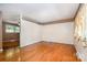 Spacious living room featuring hardwood floors, wallpapered accent, and lots of natural light throughout at 3624 Delgany Dr, Charlotte, NC 28215