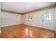 Bright living room with hardwood floors, neutral walls, and natural light streaming through a large window at 3624 Delgany Dr, Charlotte, NC 28215