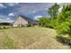 Expansive backyard featuring a manicured lawn, patio area, sunroom, and mature trees for added privacy at 4211 Maggie Springs Way, Clover, SC 29710