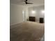 Neutral carpeted bedroom with ceiling fan, door, storage and mini-fridge at 4211 Maggie Springs Way, Clover, SC 29710
