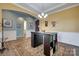 Formal dining room with modern chandelier, light hardwood flooring, archway, and elegant neutral-toned wall decor at 4211 Maggie Springs Way, Clover, SC 29710