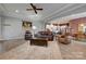 Bright living room with a fireplace, comfortable seating, ceiling fan and open layout to the kitchen at 4211 Maggie Springs Way, Clover, SC 29710