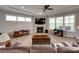 Cozy living room with a fireplace, large windows, comfortable seating, and an entertainment center at 4211 Maggie Springs Way, Clover, SC 29710