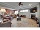 Open concept living room with a fireplace, comfortable leather seating, and an adjacent dining area at 4211 Maggie Springs Way, Clover, SC 29710