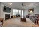 Living room featuring a fireplace, large windows, comfortable seating, and a ceiling fan at 4211 Maggie Springs Way, Clover, SC 29710
