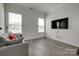 Cozy living room with gray sofa, wood floors, and large windows at 4211 Maggie Springs Way, Clover, SC 29710