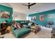 Inviting living area showcasing a plush green sofa, artwork, and ceiling fan at 4211 Maggie Springs Way, Clover, SC 29710