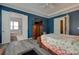 Elegant main bedroom featuring blue walls, tray ceilings, wood floors, and access to the Primary bathroom at 4211 Maggie Springs Way, Clover, SC 29710