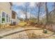 The backyard featuring a brick patio, grass, trees, and a view of the neighboring home exteriors at 4254 Black Ct # 231, Harrisburg, NC 28075