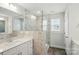 Bathroom with marble-tiled shower, dual vanity sinks, and gray wood floors at 4254 Black Ct # 231, Harrisburg, NC 28075