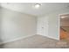Neutral bedroom with carpet and view into the hallway at 4254 Black Ct # 231, Harrisburg, NC 28075
