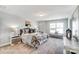 Well-lit bedroom with neutral colors, a comfortable bed, and a seating area by the window at 4254 Black Ct # 231, Harrisburg, NC 28075