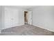 A cozy bedroom featuring carpeted floors, neutral walls, and a closet with stylish, white double doors at 4254 Black Ct # 231, Harrisburg, NC 28075
