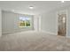 Bedroom with a large window and neutral carpet with a doorway to bathroom at 4254 Black Ct # 231, Harrisburg, NC 28075