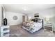 Well-lit bedroom with neutral colors, a comfortable bed, and stylish decorations at 4254 Black Ct # 231, Harrisburg, NC 28075