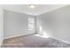 Bright bedroom with carpeted floors and natural light from a window at 4254 Black Ct # 231, Harrisburg, NC 28075