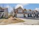 View of modern townhome exteriors with brick and siding, complemented by well-kept lawns at 4254 Black Ct # 231, Harrisburg, NC 28075