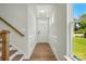 Bright foyer featuring hardwood floors, white wainscoting, and stairs with wooden railing at 4254 Black Ct # 231, Harrisburg, NC 28075