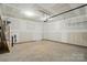 Unfinished garage with white walls, garage door opener and concrete flooring at 4254 Black Ct # 231, Harrisburg, NC 28075