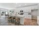 Modern white kitchen featuring a central island with seating and stainless steel appliances at 4254 Black Ct # 231, Harrisburg, NC 28075