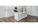 Modern kitchen island with white countertops, a sink, and stylish black faucet at 4254 Black Ct # 231, Harrisburg, NC 28075