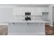 Spacious kitchen island with white countertops and a sleek black faucet, perfect for entertaining at 4254 Black Ct # 231, Harrisburg, NC 28075