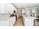 Well-lit kitchen with white cabinetry, stainless steel appliances, and a large center island at 4254 Black Ct # 231, Harrisburg, NC 28075