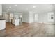 Open-concept living room features hardwood flooring and abundant natural light at 4254 Black Ct # 231, Harrisburg, NC 28075