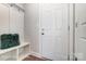 Cozy mudroom area with bench seating, hooks, and a white door at 4254 Black Ct # 231, Harrisburg, NC 28075