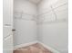 Bright walk-in closet featuring wire shelving and neutral carpet at 4254 Black Ct # 231, Harrisburg, NC 28075