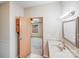 Compact bathroom with a classic vanity, mirror and connecting bedroom view at 4408 Robins Nest Rd, Concord, NC 28027