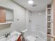 Well-lit bathroom featuring a shower-tub combo with open shelving for storage at 4408 Robins Nest Rd, Concord, NC 28027