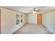Bedroom with carpet, a ceiling fan, and a large window that provides ample natural light at 4408 Robins Nest Rd, Concord, NC 28027