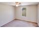 This bedroom has carpet floors, a ceiling fan, and a window overlooking the yard at 4408 Robins Nest Rd, Concord, NC 28027